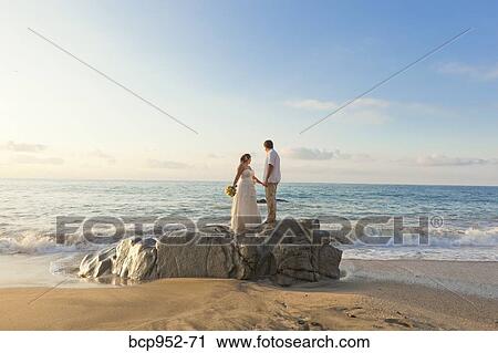 bridal couple hugging on beach View Large Photo Image Stock Image - bridal couple hugging on beach. Fotosearch