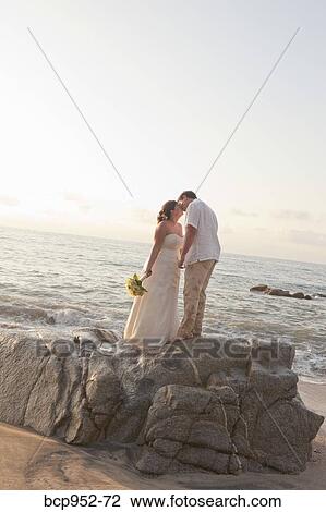 bridal couple hugging on beach View Large Photo Image Stock Image - bridal couple hugging on beach. Fotosearch