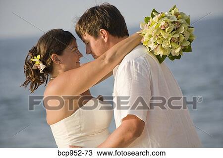 bridal couple hugging on beach View Large Photo Image Stock Image - bridal couple hugging on beach. Fotosearch