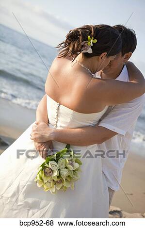 bridal couple hugging on beach View Large Photo Image Stock Photo - bridal couple hugging on beach. Fotosearch