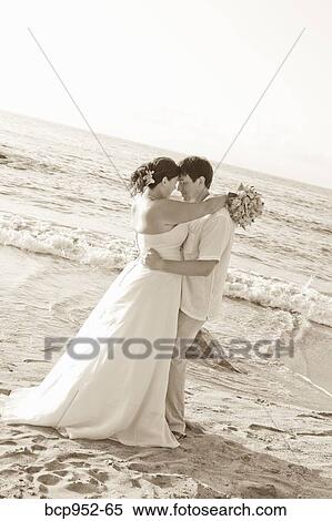 Stock Photography - bridal couple hugging on beach. Fotosearch