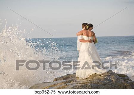 Stock Photography - bridal couple hugging on beach. Fotosearch