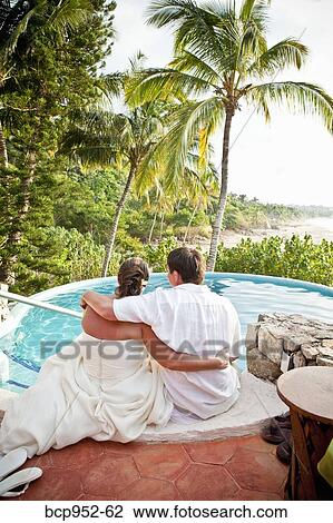 bridal couple sitting with feet in pool View Large Photo Image Stock Image - bridal couple sitting with feet in pool. Fotosearch