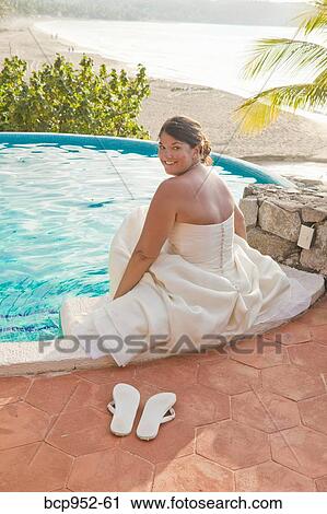 bride sitting with feet in pool View Large Photo Image Stock Image - bride sitting with feet in pool. Fotosearch