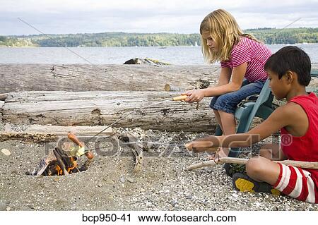 children roasting hotdogs over beach fire View Large Photo Image Stock Image - children roasting hotdogs over beach fire. Fotosearch
