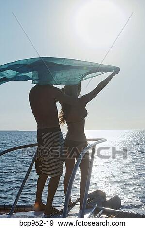 couple on bow of yacht with flying sari View Large Photo Image Stock Photo - couple on bow of yacht with flying sari. Fotosearch
