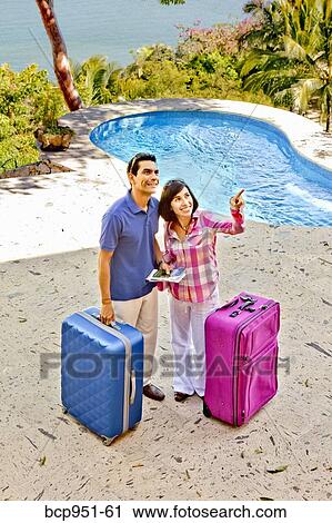 Stock Image - couple outdoors with luggage. Fotosearch