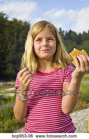 girl eating s'more outdoors View Large Photo Image Stock Photograph - girl eating s'more outdoors. Fotosearch
