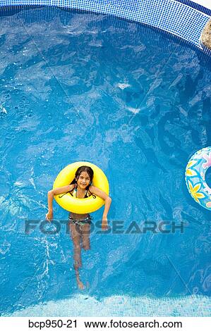 girl in yellow life ring in pool View Large Photo Image Stock Image - girl in yellow life ring in pool. Fotosearch
