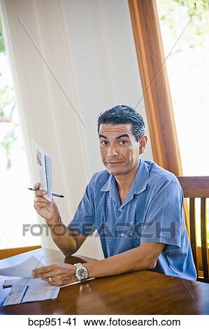man at table with bills View Large Photo Image Stock Image - man at table with bills. Fotosearch