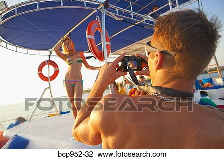 man taking photo of woman in bikini View Large Photo Image Stock Image - man taking photo of woman in bikini. Fotosearch