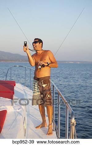 man with camera on deck of yacht View Large Photo Image Stock Photo - man with camera on deck of yacht. Fotosearch