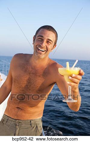 man with cocktail on yacht View Large Photo Image Stock Image - man with cocktail on yacht. Fotosearch