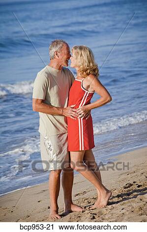 middle aged couple hugging on beach View Large Photo Image Stock Image - middle aged couple hugging on beach. Fotosearch