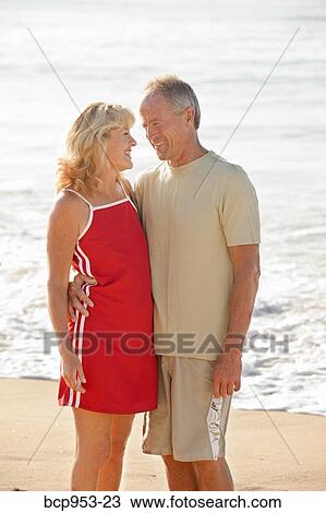 middle aged couple hugging on beach View Large Photo Image Stock Image - middle aged couple hugging on beach. Fotosearch