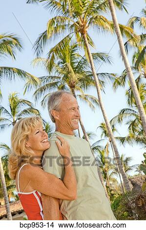 middle aged couple with palm trees View Large Photo Image Picture - middle aged couple with palm trees. Fotosearch