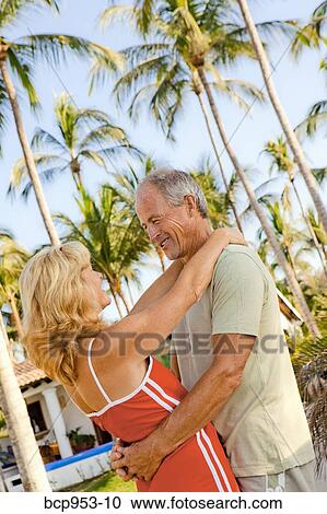 middle aged couple with palm trees View Large Photo Image Stock Image - middle aged couple with palm trees. Fotosearch