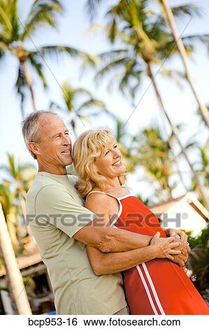 middle aged couple with palm trees View Large Photo Image Stock Photograph - middle aged couple with palm trees. Fotosearch