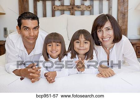 parents and two daughters on bed View Large Photo Image Stock Photo - parents and two daughters on bed. Fotosearch