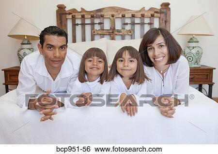 parents and two daughters on bed View Large Photo Image Stock Photograph - parents and two daughters on bed. Fotosearch