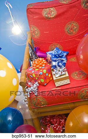 red chair with gifts and balloons View Large Photo Image Stock Image - red chair with gifts and balloons. Fotosearch