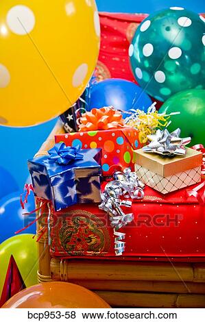 Stock Photo - red chair with gifts and balloons. Fotosearch
