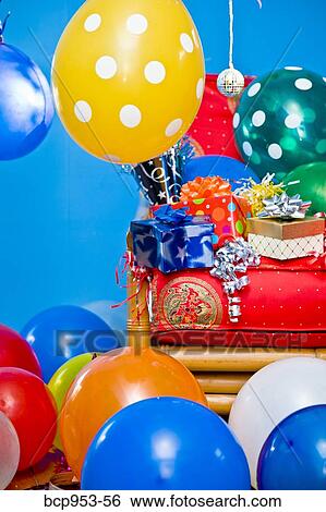 Stock Photograph - red chair with gifts and balloons. Fotosearch