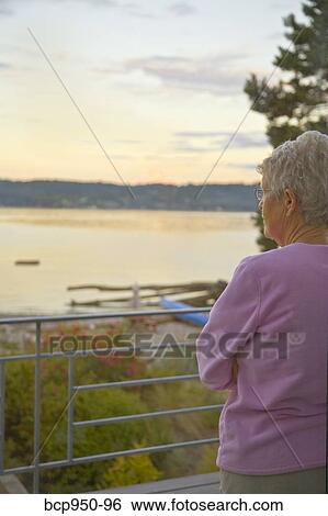 senior woman gazing at beach view View Large Photo Image Stock Photograph - senior woman gazing at beach view. Fotosearch