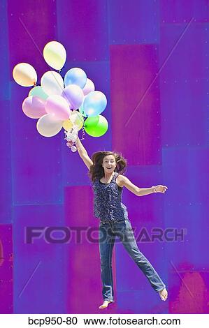 teen girl holding bunch of balloons View Large Photo Image Stock Image - teen girl holding bunch of balloons. Fotosearch