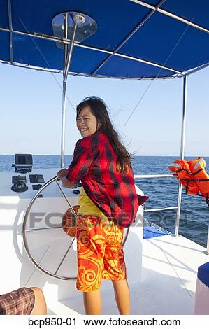 teen girl steering yacht View Large Photo Image Stock Image - teen girl steering yacht. Fotosearch