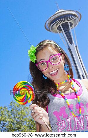 teen girl with lollipop and space needle View Large Photo Image Stock Photo - teen girl with lollipop and space needle. Fotosearch