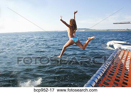 woman jumping off yacht into sea View Large Photo Image Stock Photo - woman jumping off yacht into sea. Fotosearch