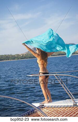 woman on bow of yacht with flying sari View Large Photo Image Stock Image - woman on bow of yacht with flying sari. Fotosearch