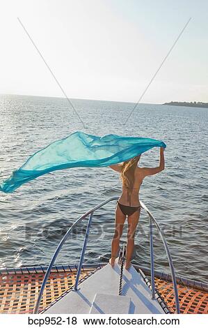 woman on bow of yacht with flying sari View Large Photo Image Stock Photo - woman on bow of yacht with flying sari. Fotosearch