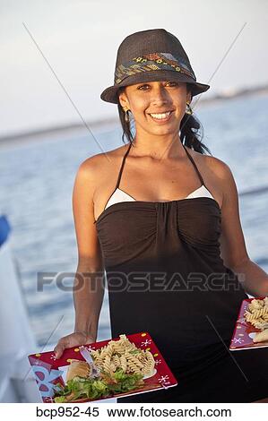 woman on yacht holding plates of food View Large Photo Image Stock Photography - woman on yacht holding plates of food. Fotosearch