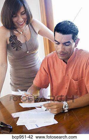 woman standing near man paying bills View Large Photo Image Stock Image - woman standing near man paying bills. Fotosearch