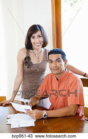 woman standing near man paying bills View Large Photo Image Stock Image - woman standing near man paying bills. Fotosearch