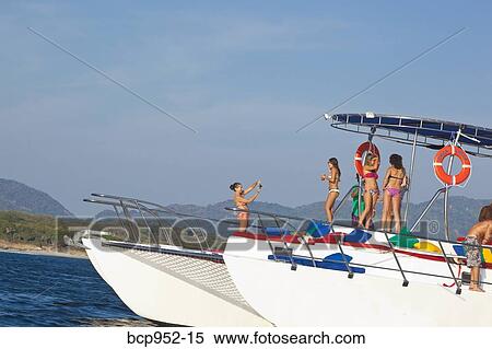 Stock Photography - young people partying on yacht. Fotosearch