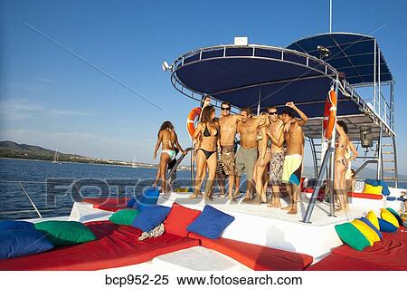 Stock Photography - young people partying on yacht. Fotosearch