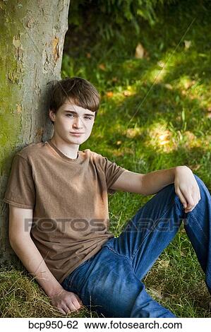 young teen boy sitting in park 12-14 years old View Large Photo Image Stock Image - young teen boy sitting in park 12-14 years old. Fotosearch