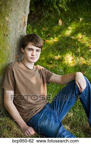 Stock Photo of young teen boy sitting in park 12-14 years old bcp950-62 ...