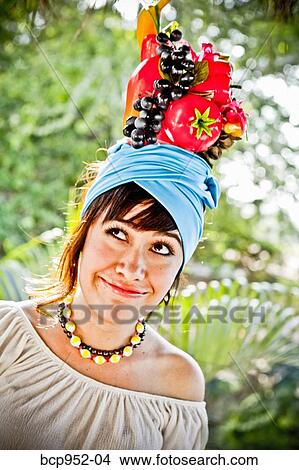 Picture - young woman wearing fruit hat. Fotosearch