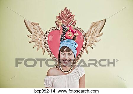 young woman wearing fruit hat View Large Photo Image Picture - young woman wearing fruit hat. Fotosearch