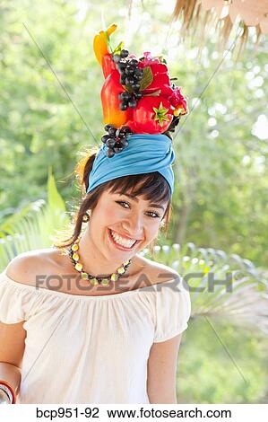 young woman wearing fruit hat View Large Photo Image Stock Image - young woman wearing fruit hat. Fotosearch