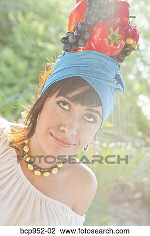 young woman wearing fruit hat View Large Photo Image Stock Image - young woman wearing fruit hat. Fotosearch