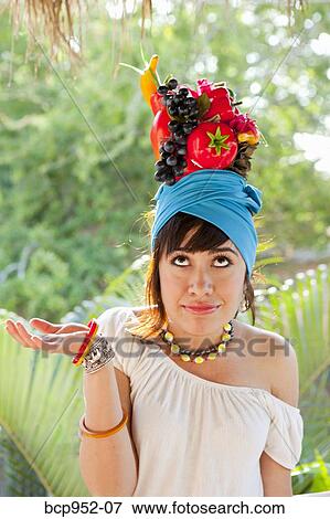 young woman wearing fruit hat View Large Photo Image Stock Photo - young woman wearing fruit hat. Fotosearch