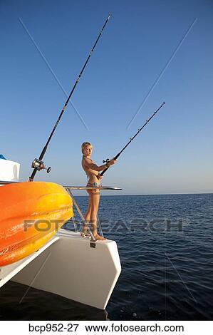 young woman with fishing pole on yacht View Large Photo Image Stock Photo - young woman with fishing pole on yacht. Fotosearch