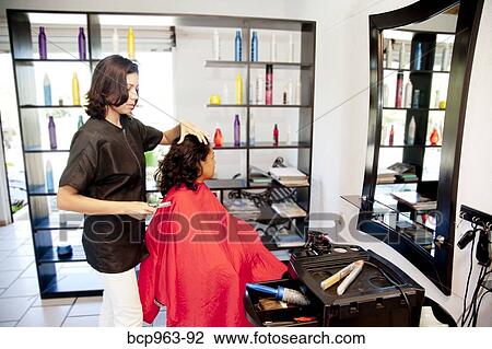 Beautician and seated customer in beauty salon View Large Photo Image Stock Image - Beautician and seated customer in beauty salon. Fotosearch