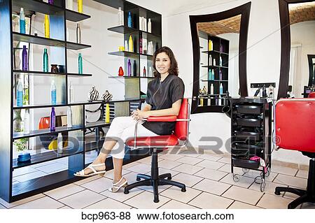 Beautician seated on chair in beauty salon View Large Photo Image Stock Photo - Beautician seated on chair in beauty salon. Fotosearch