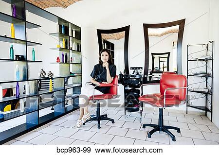 Beautician seated on chair in beauty salon View Large Photo Image Stock Photo - Beautician seated on chair in beauty salon. Fotosearch